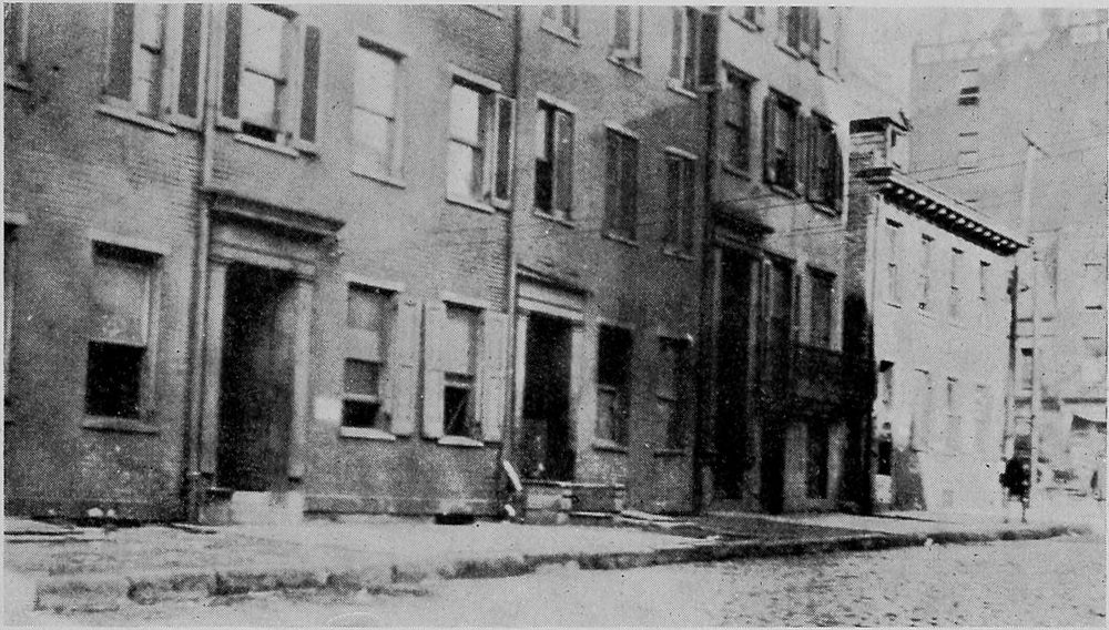A Row of Dilapidated Old Dwellings in the Downtown
Section Used as Rooming Houses for Migrants.