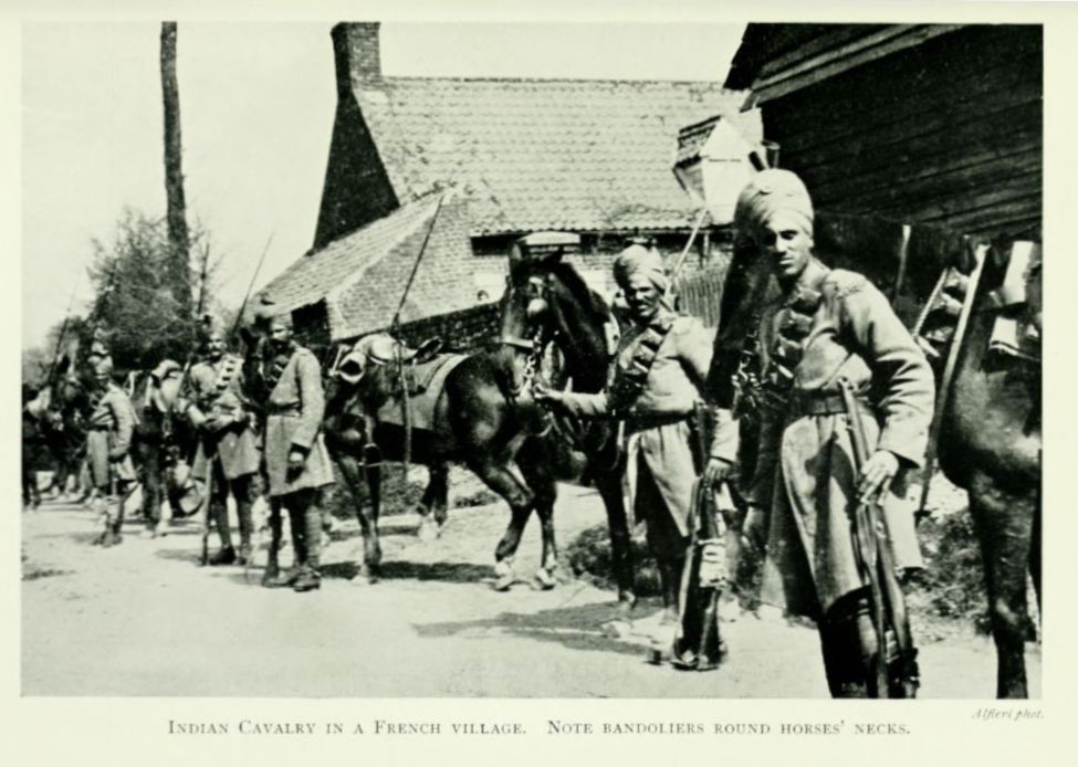 Indian Cavalry in a French village. Note bandoliers round horses’
necks.
