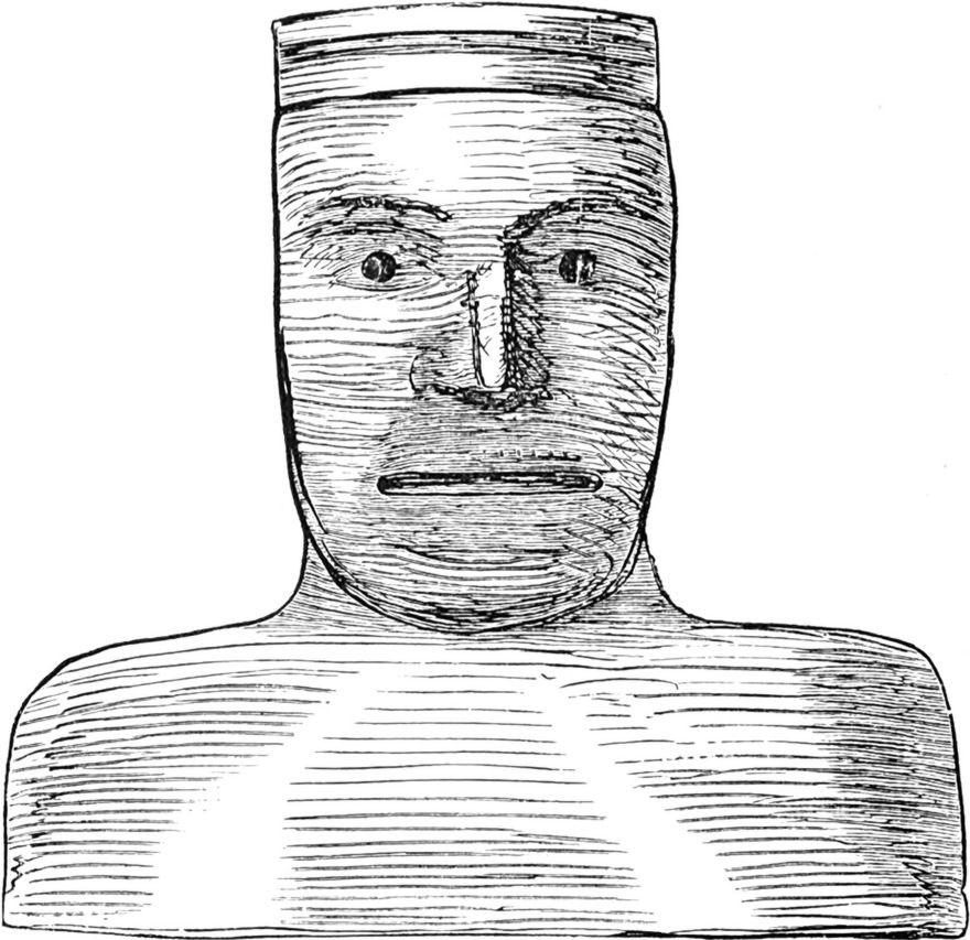 In Holz geschnitzter
  männlicher Kopf als Schutzgottheit